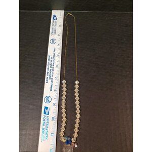 25 inch gold plated necklace with clear beading and heart and flower charms.